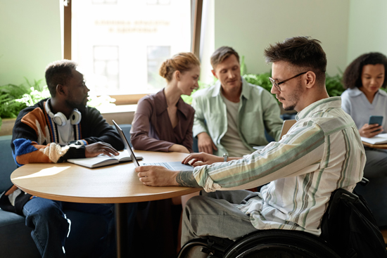 Out in the community participation - man with disability sitting at meeting